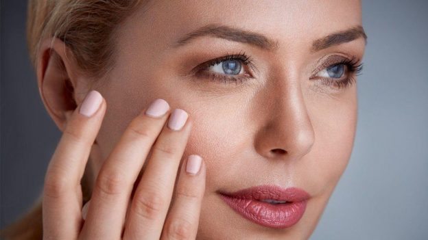 A women helping to reduce the signs of aging with Cenegenics cream