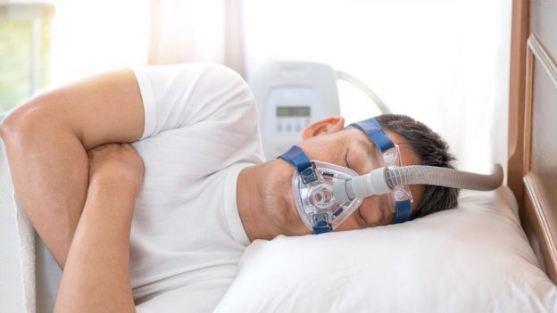 A man sleeping with sleep apnea