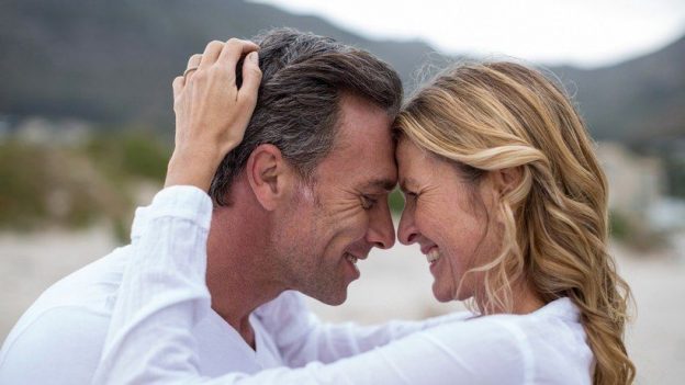 happy couple smiling at eachother, hormone replacement therapy can increase sex drive due to optimal testosterone levels