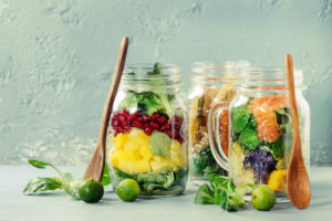 Variety of salads in mason jars to eat healthy while working from home