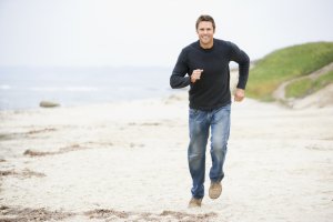Mature man running on beach