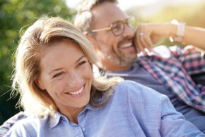 mature couple smiling while sitting outside overcoming depression