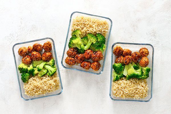 Meatballs, broccoli, and rice in glass containers for healthy meal prepping