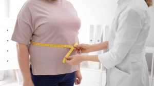 Overweight woman being measured by health professional to calculate visceral fat