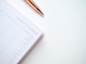 A white yearly planner with a to do list that can be beneficial for getting back on track with weight loss.