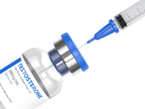 Syringe pulling testosterone from prescription vial for testosterone therapy 