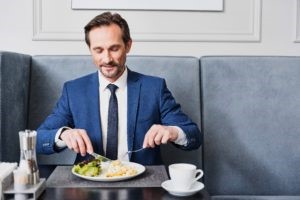 man in blue suit eating a meal with macronutrients and micronutrients 