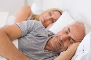Couple sleeping getting optimal sleep, reducing the risk of health issues 