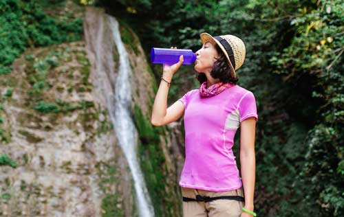 Woman drinking water to stay healthy and hydrated 