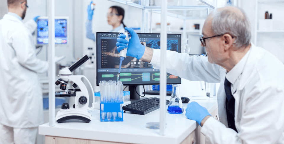 Mature Doctor in lab measuring blood sample for telomere test, biological age prognosis via blood test