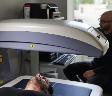 Man getting a dexa scan in a Cenegenics center
