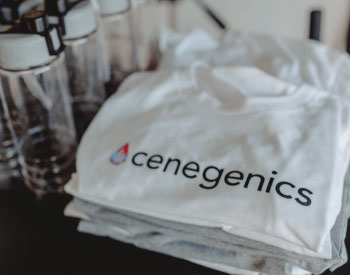 Cenegenics shirts stacked next to water bottles in gym